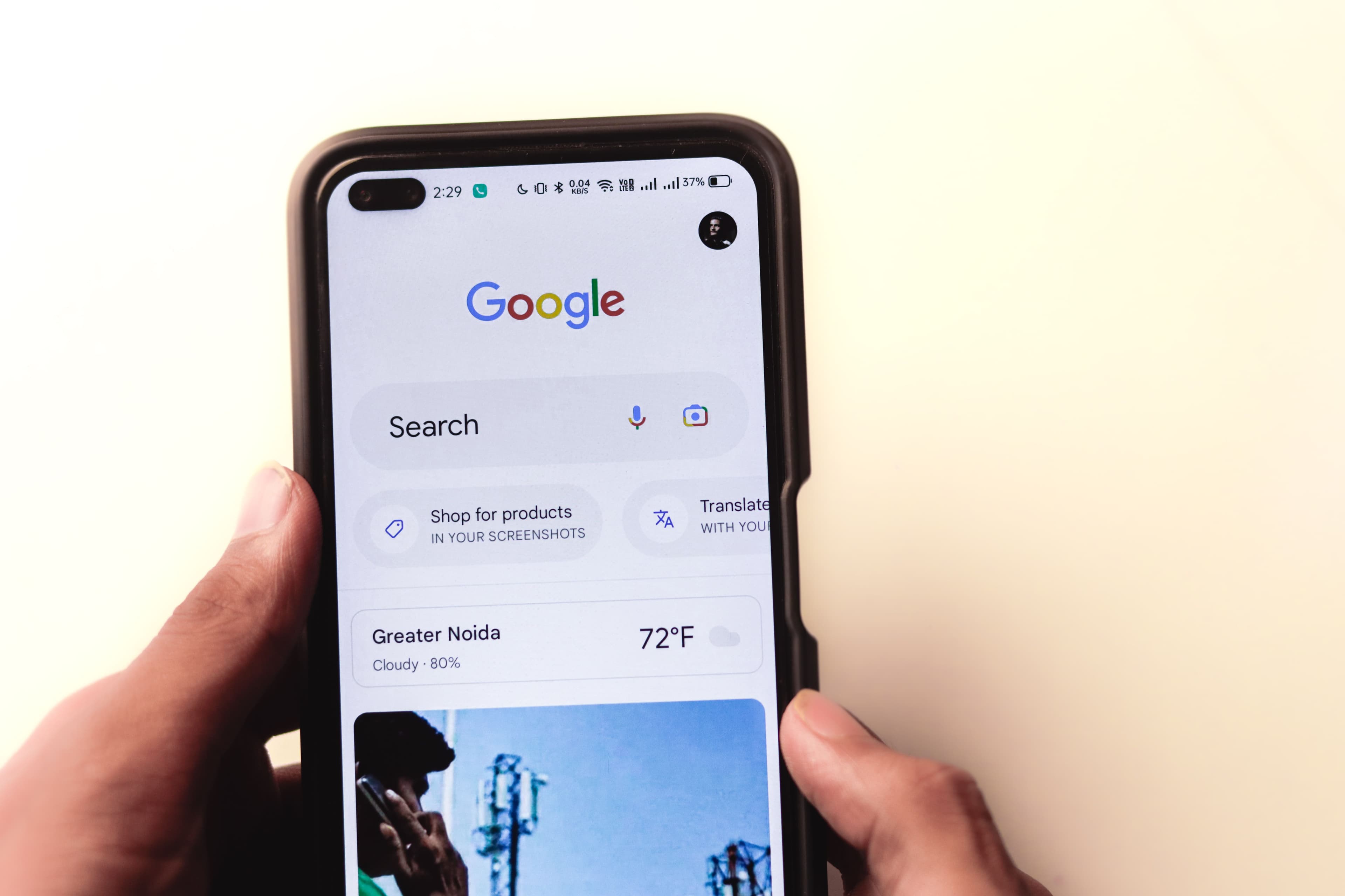 Someone running a Google search on a phone, the moment a nearby business needs to appear.