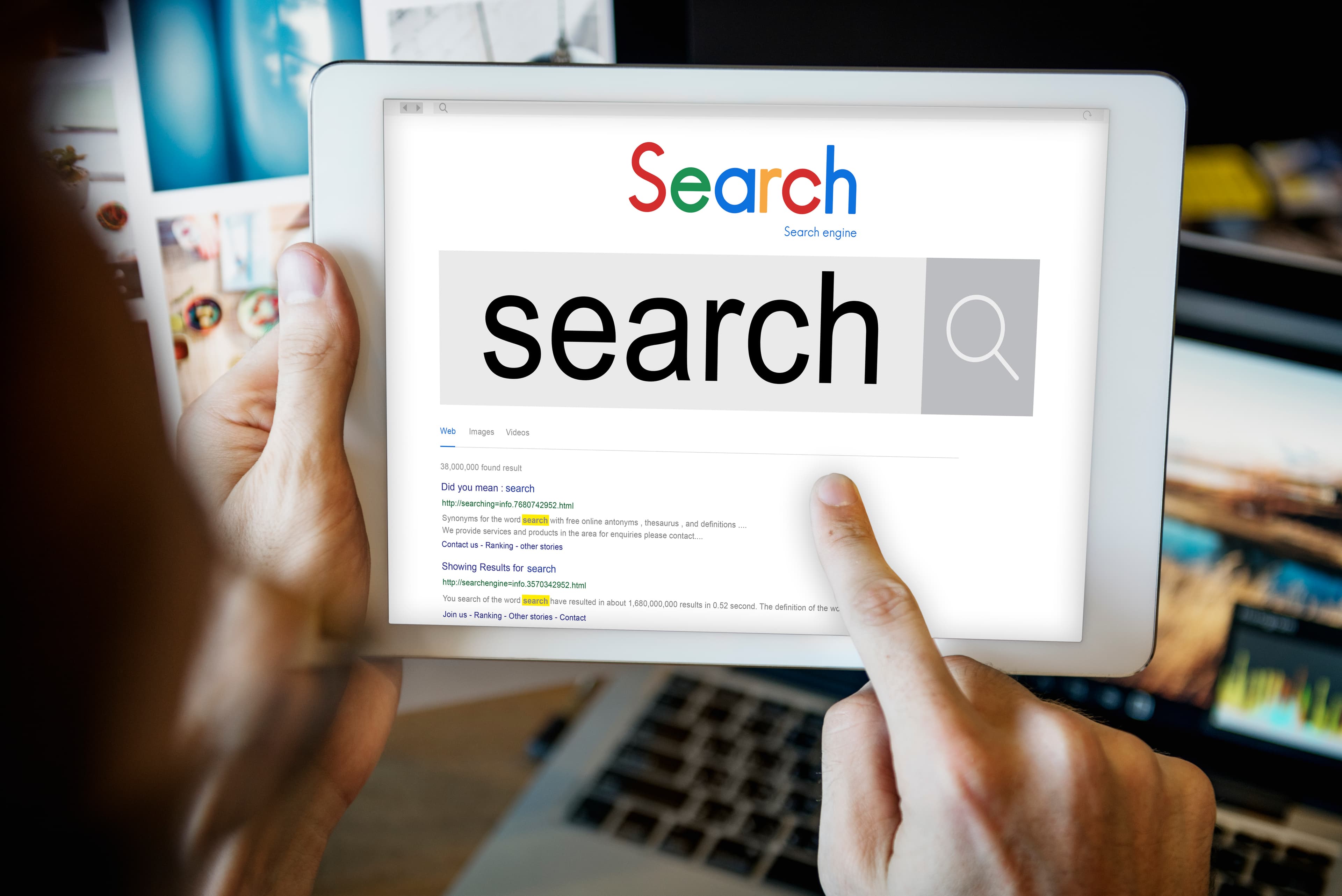Hands holding a tablet showing a search engine results page.
